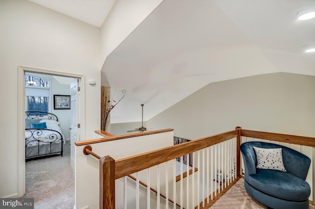 hallway with vaulted ceiling and carpet floors