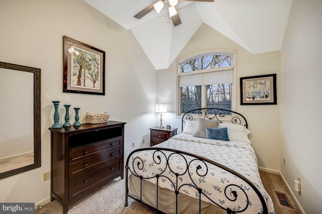 carpeted bedroom with ceiling fan and vaulted ceiling