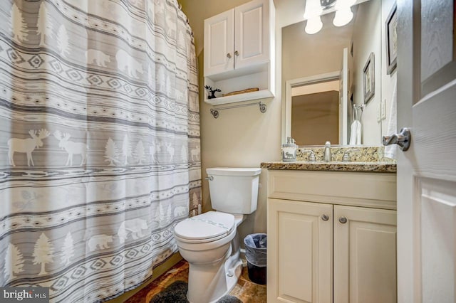 bathroom with vanity, toilet, and tile floors