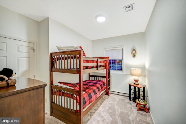 bedroom featuring a baseboard radiator, a closet, and light colored carpet