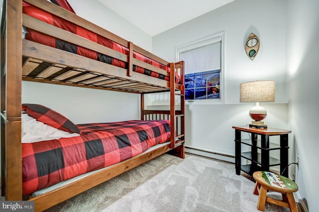 bedroom featuring baseboard heating and carpet