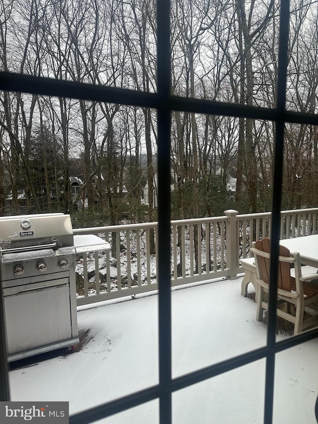 snow covered patio featuring area for grilling