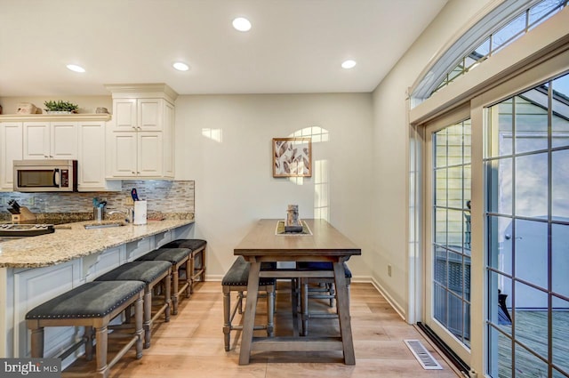 dining area featuring light wood-type flooring