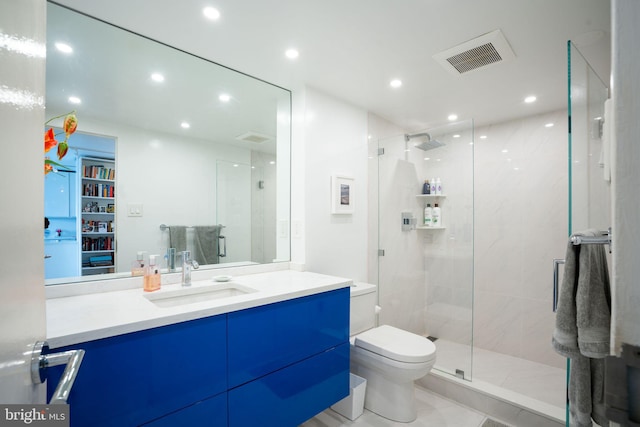 bathroom featuring an enclosed shower, tile flooring, vanity with extensive cabinet space, and toilet