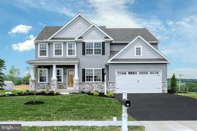 craftsman-style home with covered porch and a front lawn