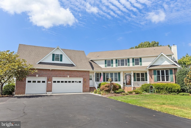 view of front of house with a front yard and a garage