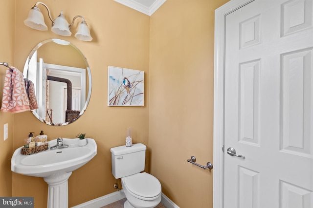 bathroom with ornamental molding and toilet