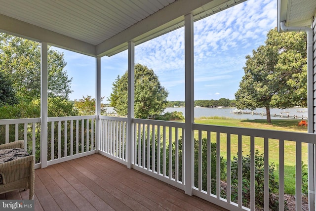 unfurnished sunroom featuring a water view