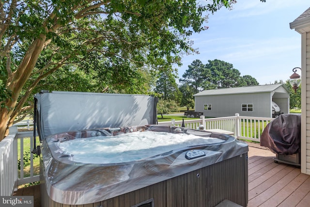 wooden deck featuring area for grilling and a hot tub