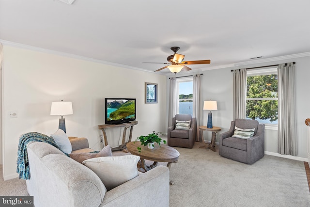 carpeted living room featuring ornamental molding, ceiling fan, and a water view