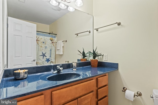 bathroom featuring toilet and vanity