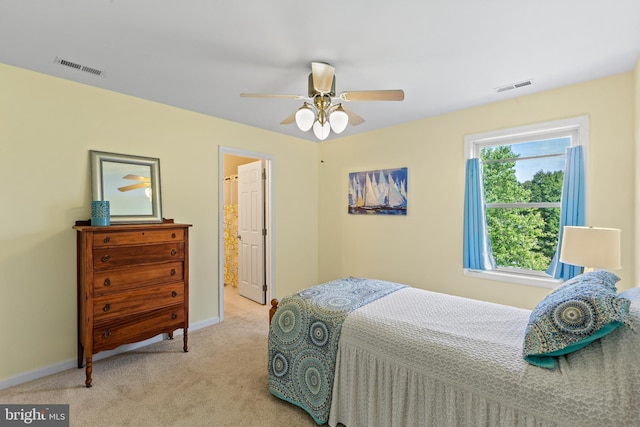 bedroom with connected bathroom, carpet, and ceiling fan