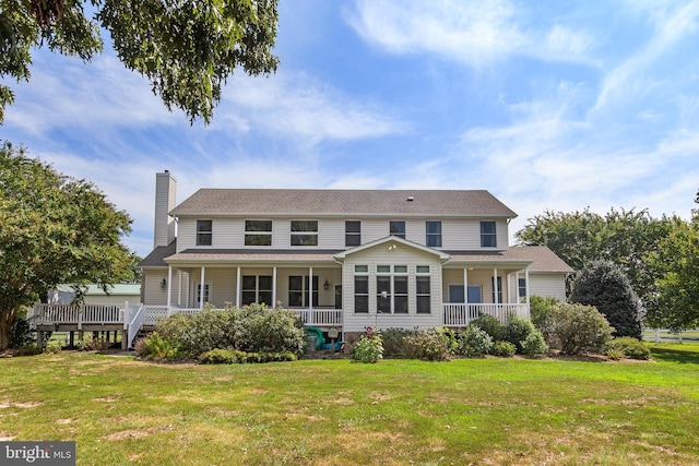 rear view of property with a porch and a yard