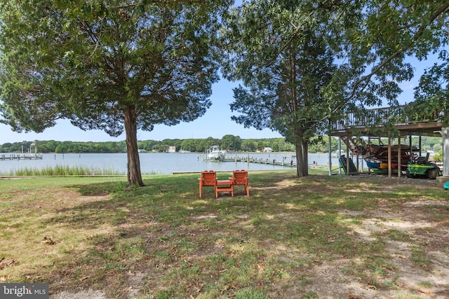 view of yard with a boat dock and a water view