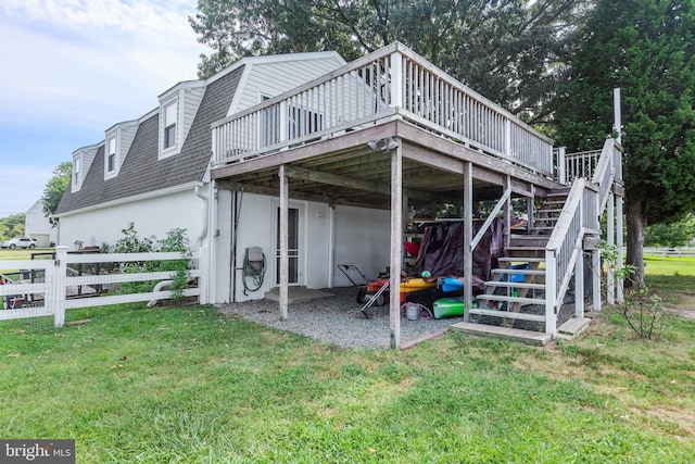 rear view of property with a yard and a wooden deck