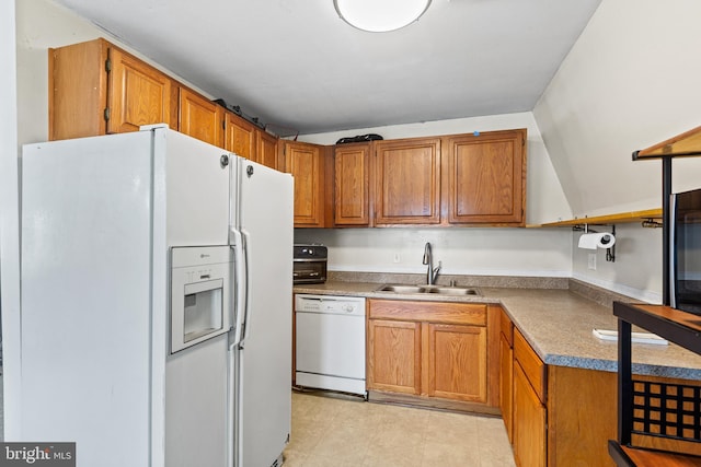 kitchen featuring sink, white appliances, and light tile flooring