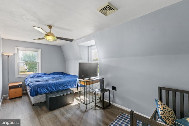 bedroom featuring dark wood-type flooring, lofted ceiling, and ceiling fan