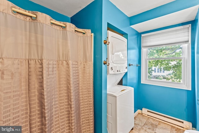 laundry room with baseboard heating, stacked washer and dryer, and light tile floors