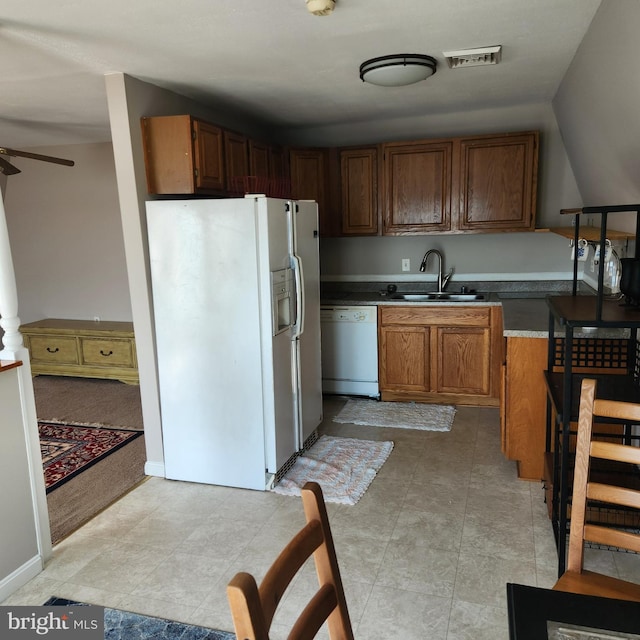 kitchen featuring white appliances, sink, light tile flooring, and ceiling fan