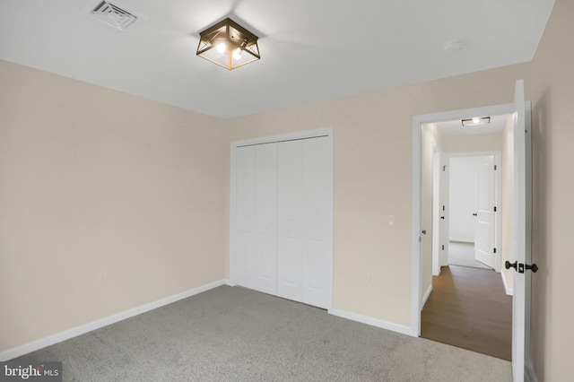 unfurnished bedroom with carpet and a closet