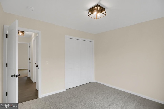 unfurnished bedroom with a closet and carpet flooring