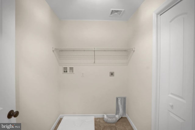 clothes washing area featuring electric dryer hookup, hookup for a washing machine, and tile patterned floors