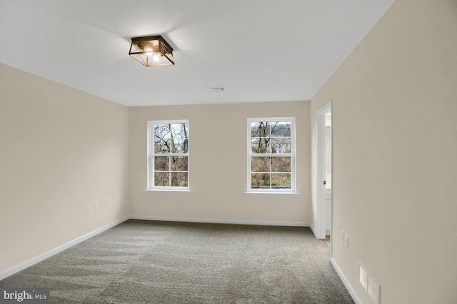 unfurnished room with light carpet