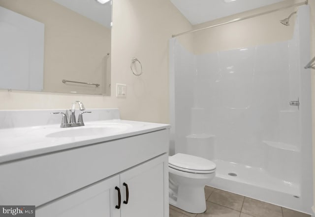 bathroom featuring a shower, toilet, tile patterned flooring, and vanity