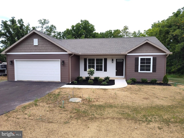 view of front of house with a garage and a front lawn