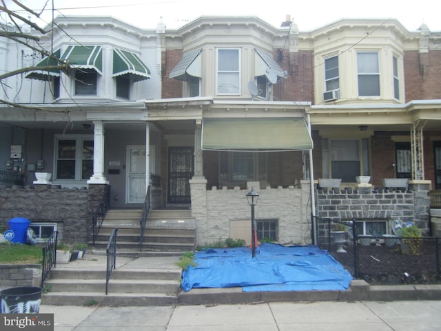 view of front of home featuring covered porch and cooling unit