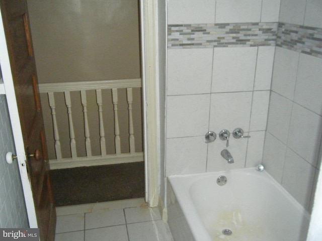 bathroom featuring a tub to relax in and tile patterned flooring