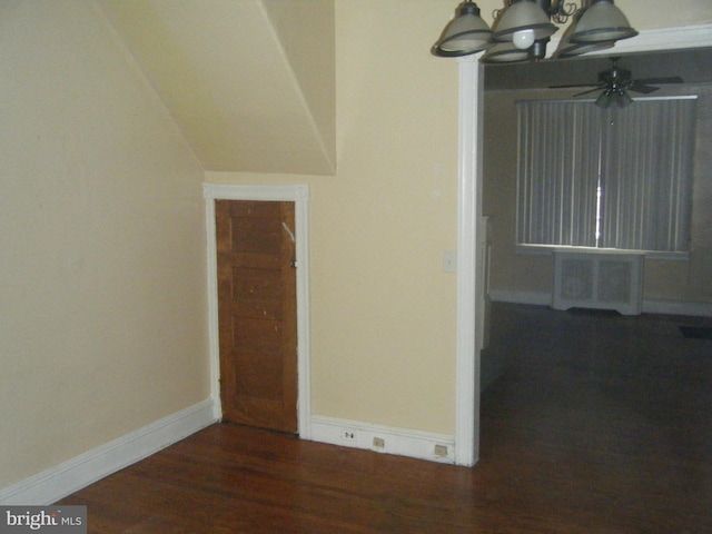 interior space featuring dark hardwood / wood-style flooring and ceiling fan with notable chandelier