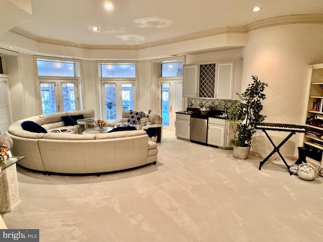 carpeted living room featuring ornamental molding