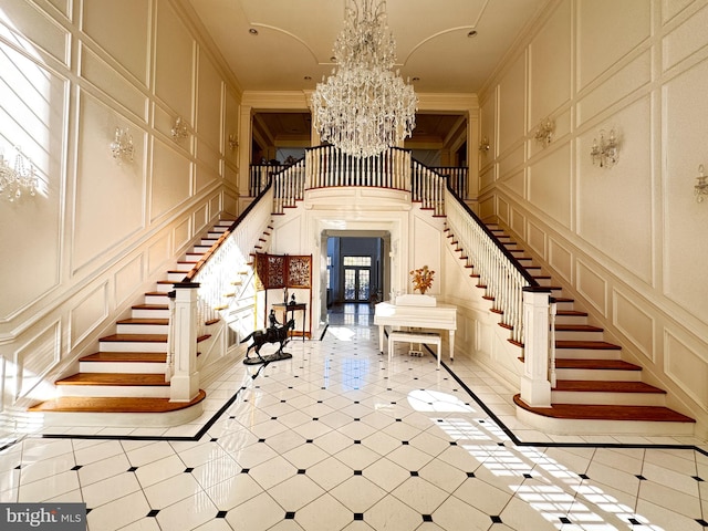 interior space with a notable chandelier, crown molding, and a healthy amount of sunlight