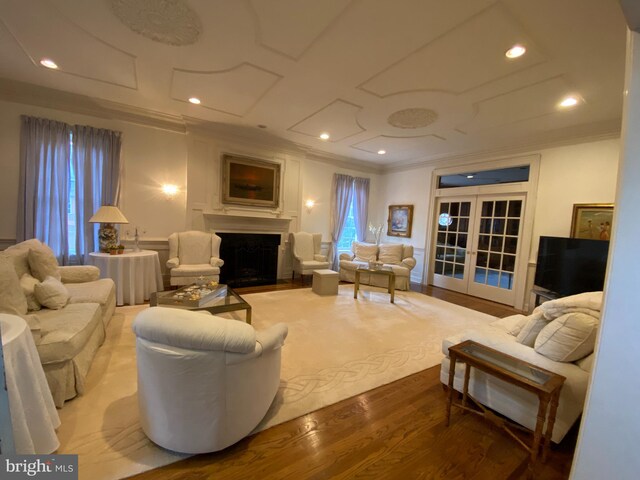 living room with wood-type flooring, french doors, ornamental molding, and a wealth of natural light