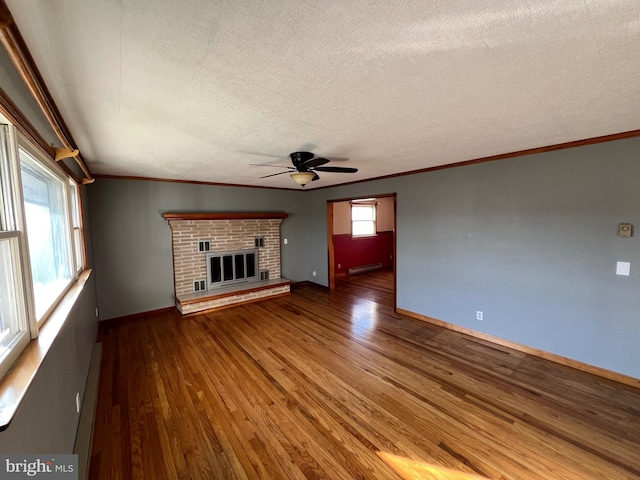 unfurnished living room featuring a baseboard radiator, ceiling fan, dark hardwood / wood-style floors, and a fireplace