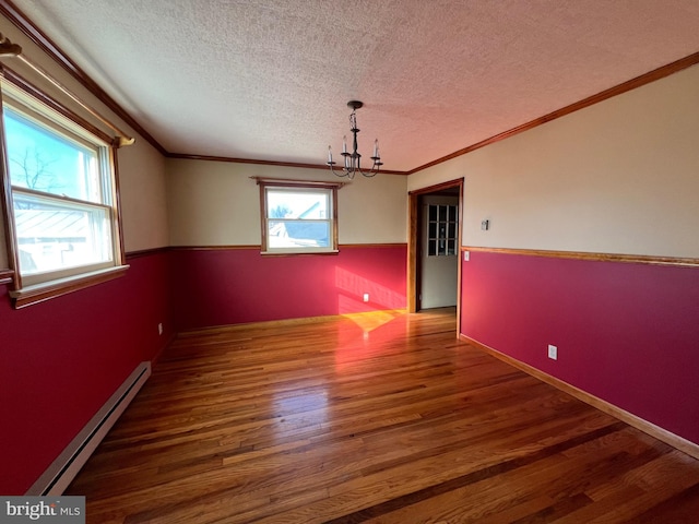 unfurnished room with dark hardwood / wood-style floors, a textured ceiling, an inviting chandelier, and baseboard heating