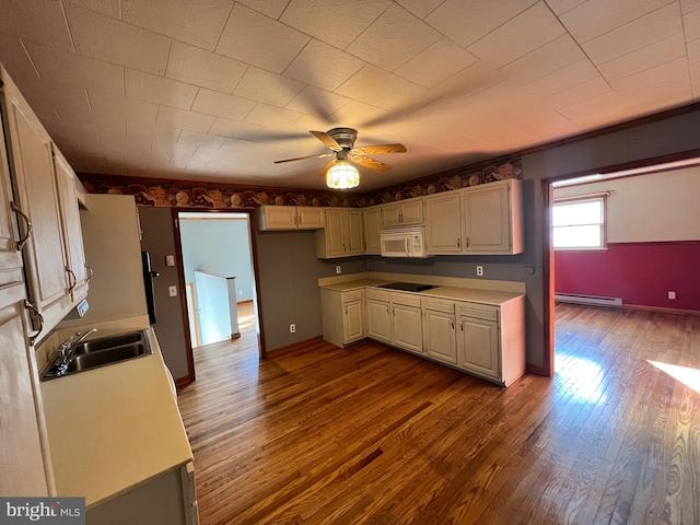 kitchen featuring dark hardwood / wood-style floors, ceiling fan, black electric cooktop, sink, and baseboard heating