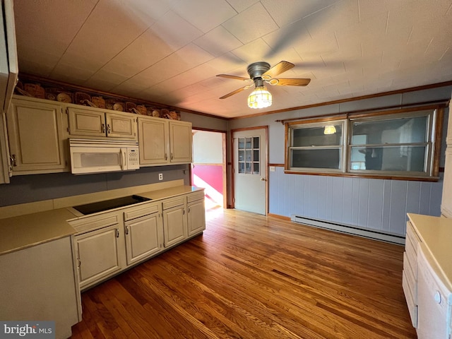 kitchen with dark hardwood / wood-style floors, black electric cooktop, ceiling fan, and a baseboard radiator