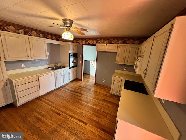 kitchen with ceiling fan, white appliances, hardwood / wood-style floors, and white cabinetry