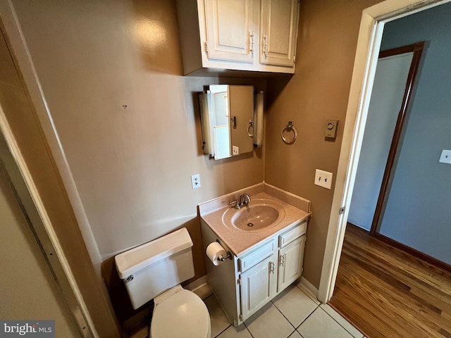 bathroom featuring tile floors, oversized vanity, and toilet