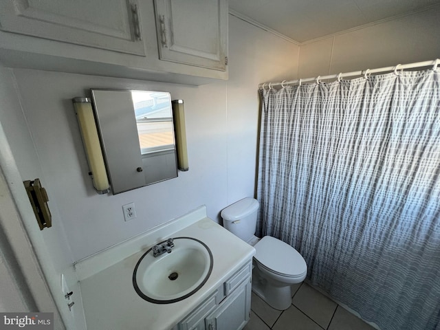 bathroom with toilet, vanity, and tile flooring