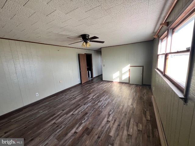 unfurnished room featuring dark hardwood / wood-style flooring and ceiling fan