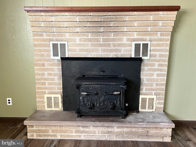 details with dark hardwood / wood-style flooring and a wood stove