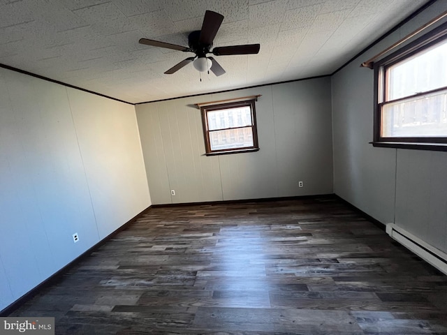 unfurnished room featuring ceiling fan, baseboard heating, and dark hardwood / wood-style flooring