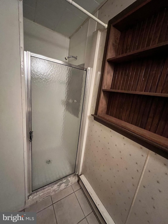 bathroom with tile flooring and an enclosed shower