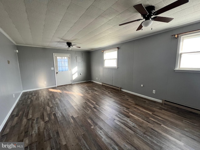 unfurnished room with dark hardwood / wood-style flooring, ceiling fan, baseboard heating, and crown molding