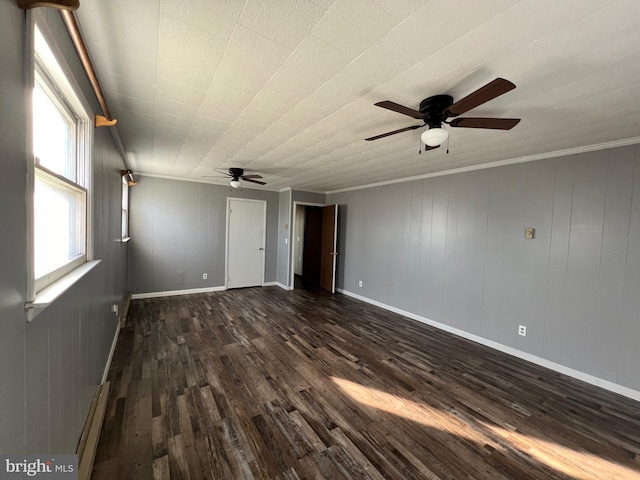 empty room featuring dark hardwood / wood-style flooring, ceiling fan, and ornamental molding