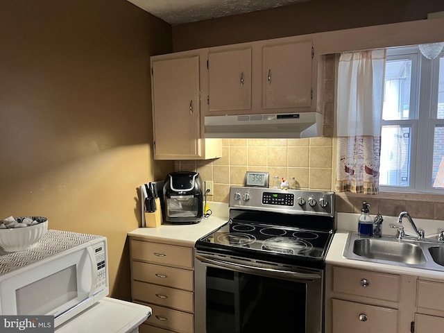 kitchen with tasteful backsplash, stainless steel electric range oven, wall chimney exhaust hood, and sink