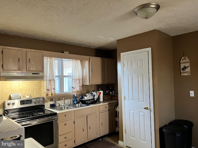 kitchen with backsplash, stainless steel electric range oven, a textured ceiling, and sink